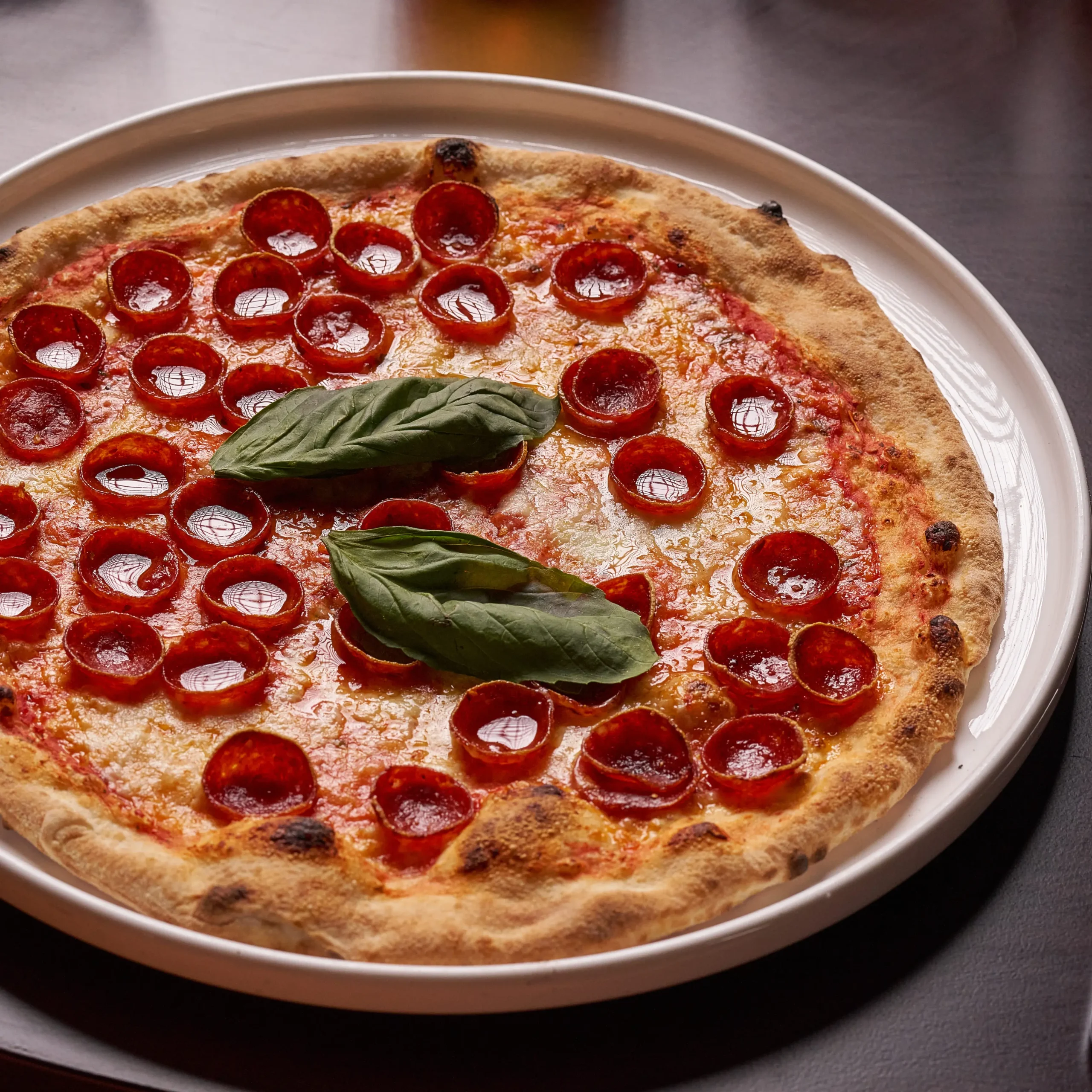 Freshly baked pepperoni pizza with melting cheese and tomato sauce